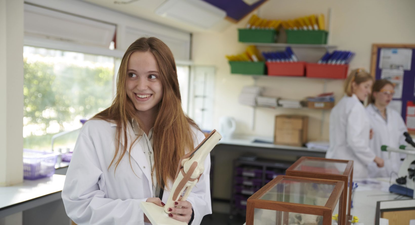 Magdalen College School pupil in lab coat studying science