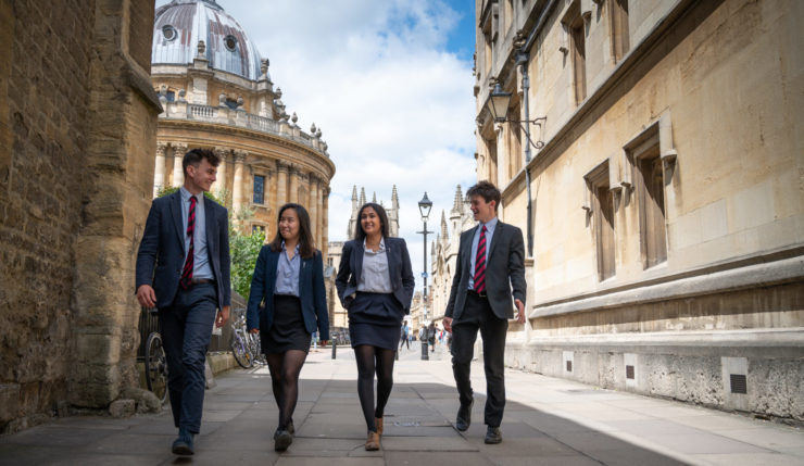 Magdalen College School Sixth Form students walking through Oxford in uniform