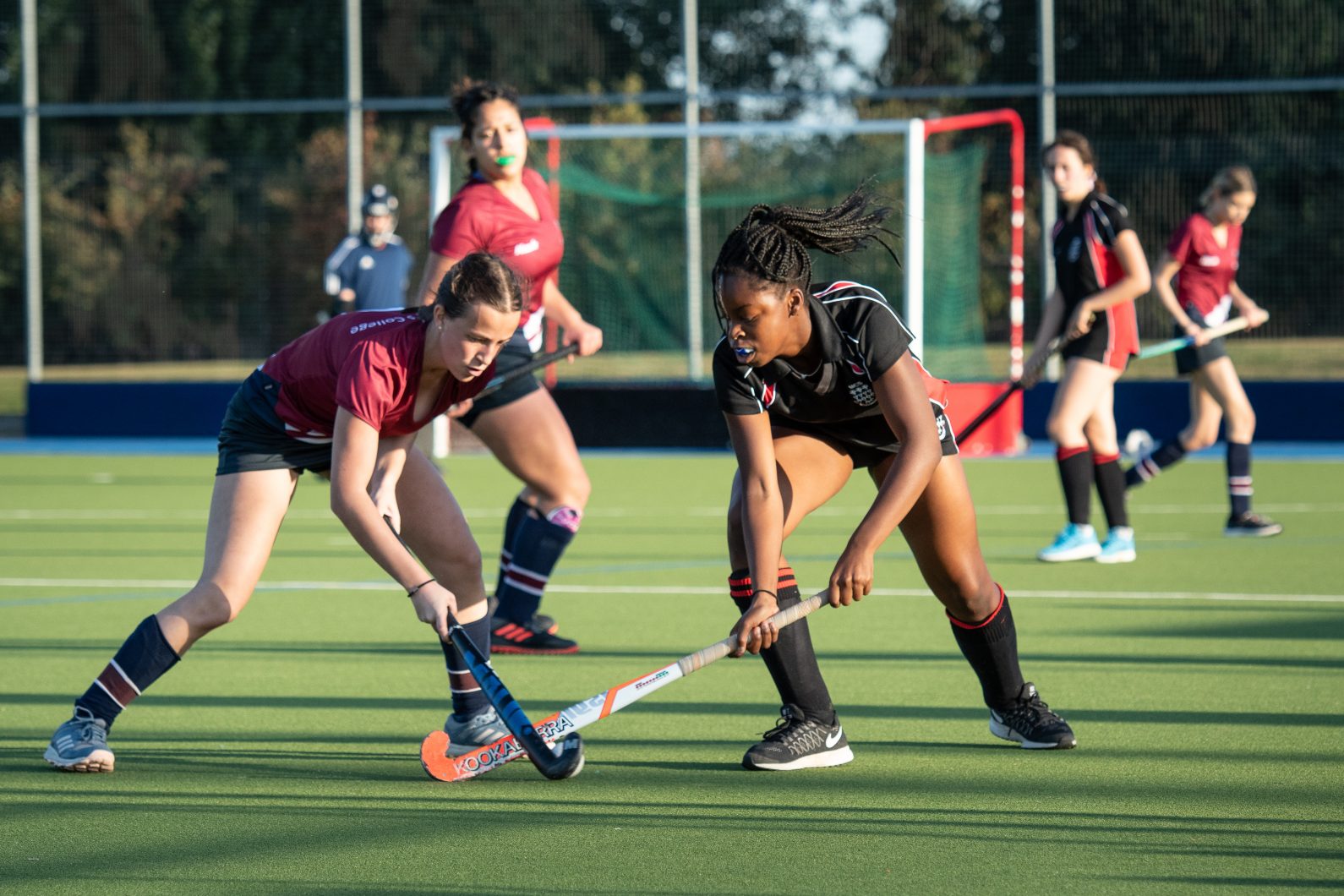 Magdalen College School Sixth Form pupils play hockey